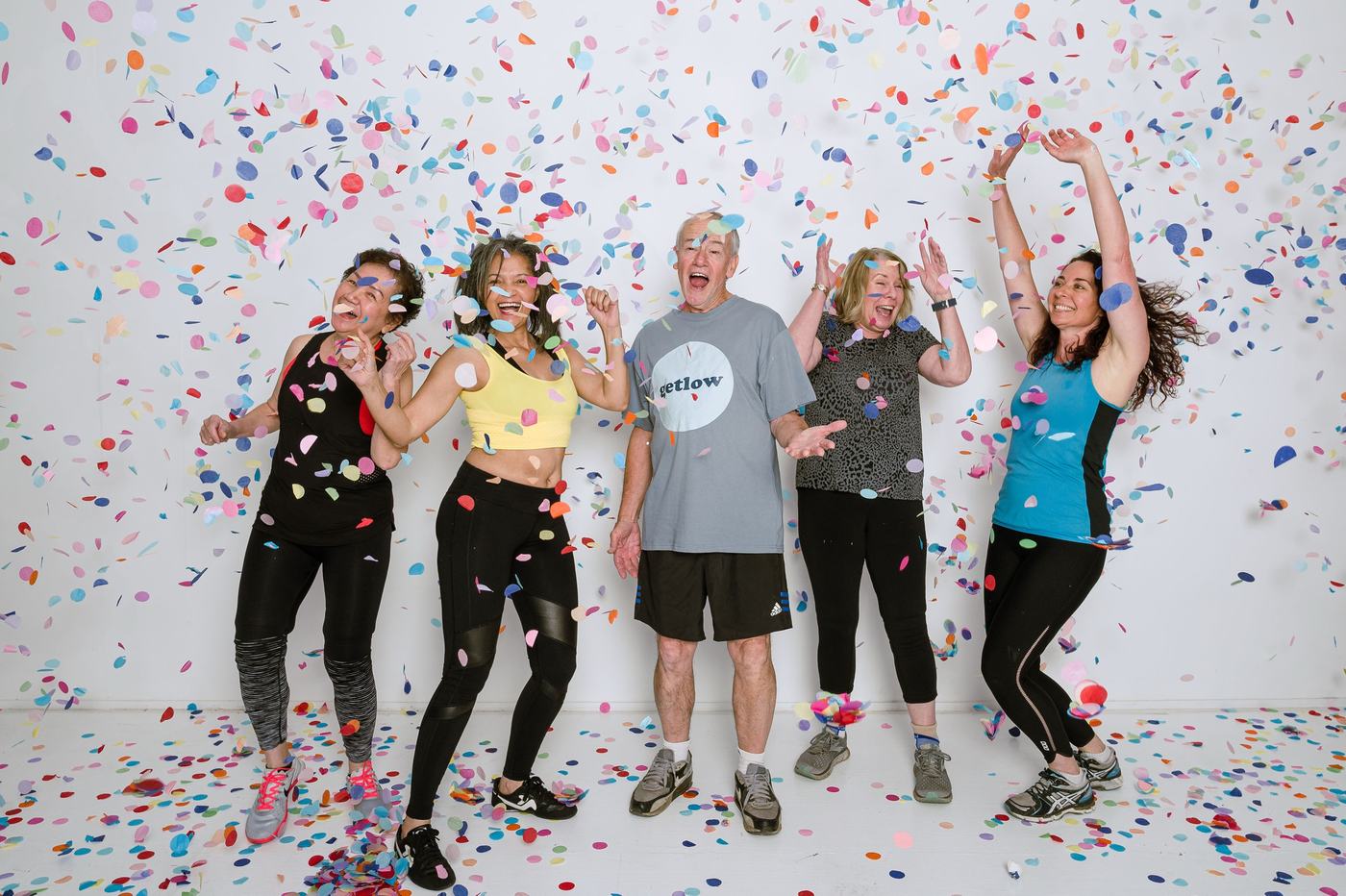 Getlow class members laughing in falling confetti