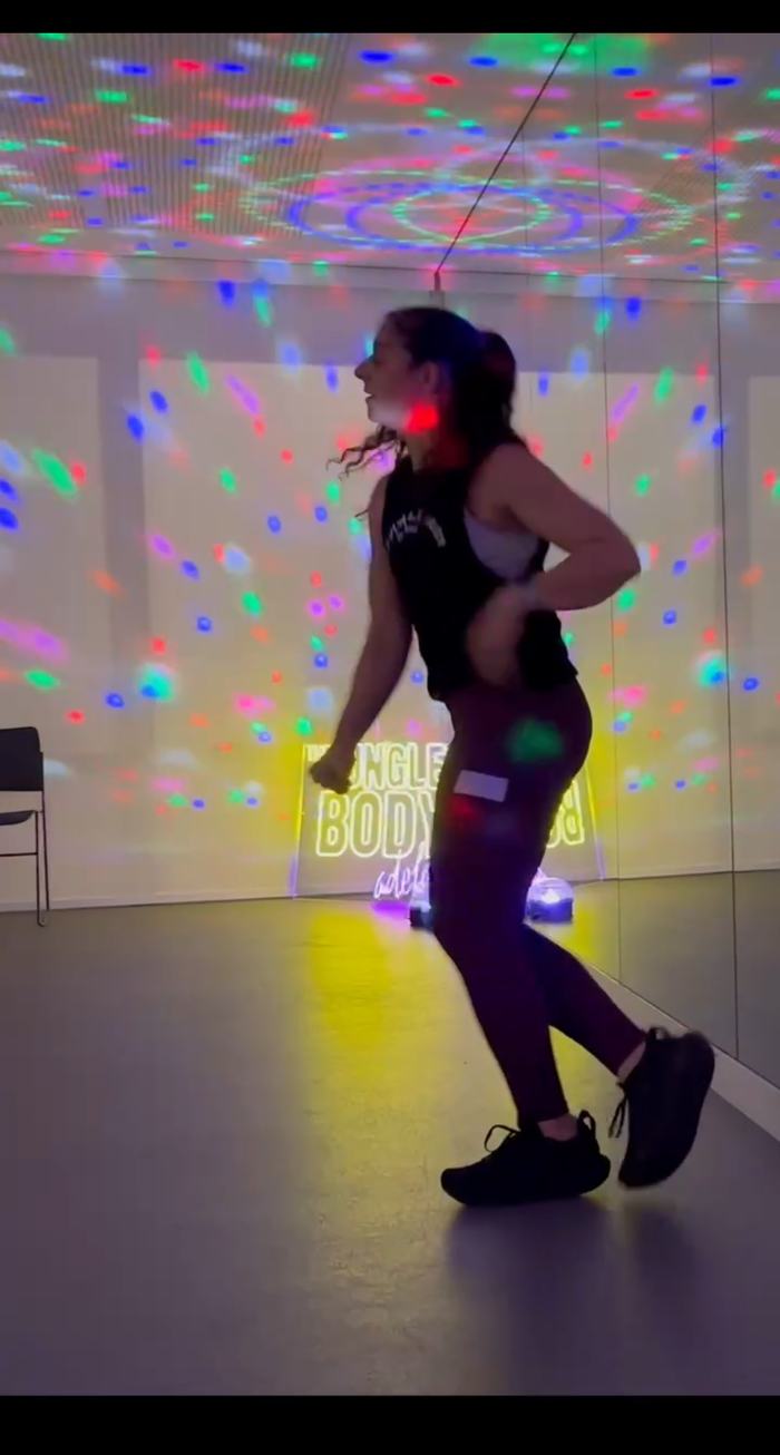Nadia dancing under disco lights